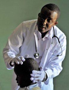 Doctor with Child at screening with New Horizons Solutions